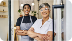 two women with arms folded 